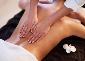 relaxed-smiling-woman-receiving-back-massage-spa-min-scaled.jpg